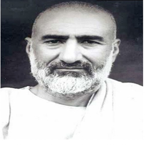 Portrait of Khan Abdul Ghaffar Khan in middle life, clean white clothing, short grey beard, looking directly at the camera.